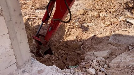 Bandage of a small excavator working in rubble on a construction site