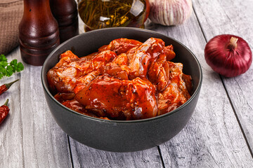 Raw marinated buffalo chicken wings