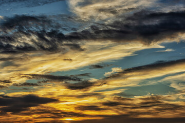 A bright sunset fills the sky with orange and blue hues