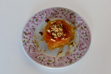 Close-up Turkish dessert kadayıf. Walnut filled kadayıf dessert