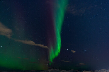 Telegrafbukta, Tromsø, Norway - 27 February 2025 - The Norwegian sky is lit up by a streak of the...