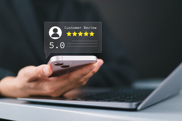 Customer review good rating concept, woman using a smartphone to view a 5-star customer review....