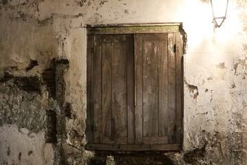 An abandoned, aged doorway with rustic charm, surrounded by cracked walls and fading history.