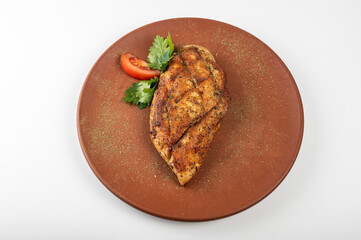 Grilled chicken breast with golden crispy seasoning on a rustic plate, garnished with fresh parsley and a tomato slice. A perfect high-protein meal for healthy eating