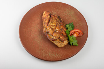 Grilled chicken breast with golden crispy seasoning on a rustic plate, garnished with fresh parsley and a tomato slice. A perfect high-protein meal for healthy eating