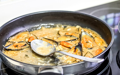 Cooking mussels in a pan.