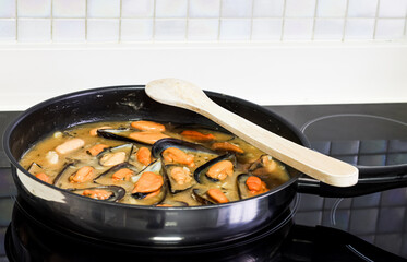 Cooking mussels in a pan.