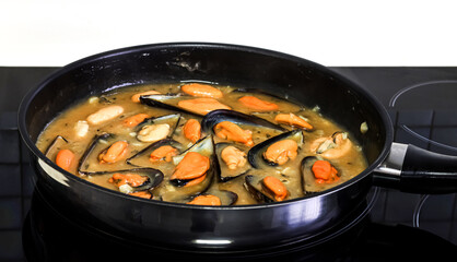 Cooking mussels in a pan.
