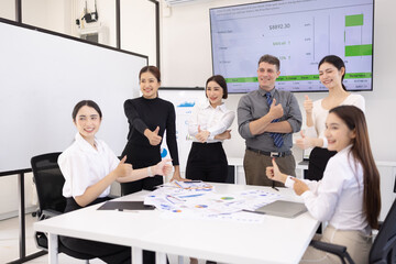 Fototapeta premium Happy excited business teamwork with marketing strategy analysis in meeting room at office, Business people working together in creative office, Business group celebrating in boardroom meeting. 