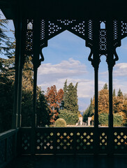 A beautifully picturesque view framed by an elegant pavilion, showcasing the vibrant colors of autumns hues