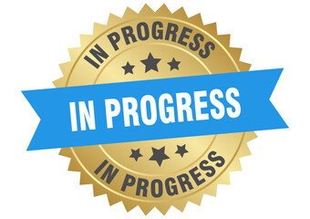 in progress. in progress round blue and gold label isolated on transparent background