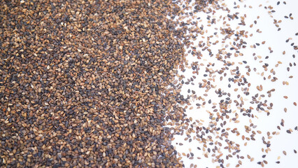 Close-Up of Organic Black Sesame seeds (Sesamum indicum) or Black Til with shell Half-Frame Background. Top View