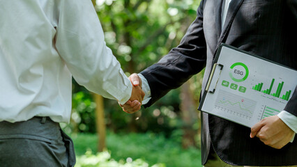 World Environment Day.ESG. business partner colleagues shaking hands working together in sustainable development goal. Sustainable business.Business value chain and Growing sustainability.CSR.