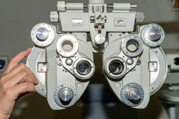 An eye exam is performed using a refractor, also called a phoropter, to determine the best corrective lenses for the patient.