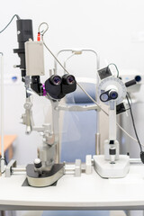 Close-up of an ophthalmic microscope, used for eye examinations, in a doctor's office. It allows detailed viewing of the eye's structures.