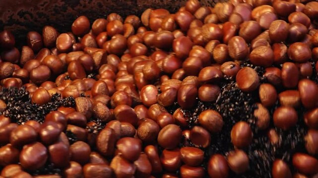 Chestnuts are cooking. The chestnuts in slow motion.