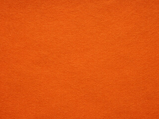 Sunset hues dance on a plush orange felt texture, inviting warmth and vibrant creativity © Dmytro Synelnychenko