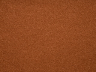 The rustic russet surface of this felt fabric whispers tales of autumn warmth and artisanal charm