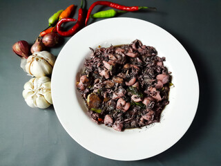 Black Squid or squid cooked with spicy taste. Indonesian food. Food that is widely loved by the community