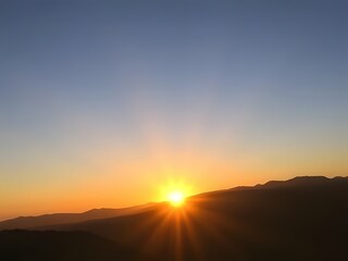 Obraz premium Stunning Sunrise Over Mountain Range Orange Sky, Silhouette Hills, Dawn, Nature's Beauty, Peaceful Scenery, Scenic View.