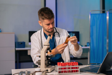 Doctor analysis the blood test examination results and medication usage of the patient on the...