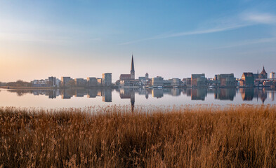 panorama of the city of rostock, early morning sunrise, view over the river warnow