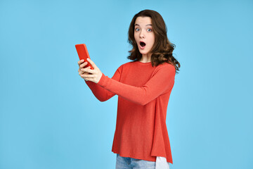 Excited young woman, girl student looking at the phone. Shock effect of news, messages, sale announcements received.