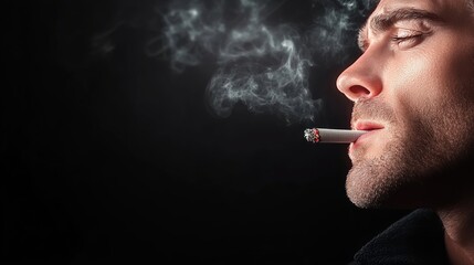 Obraz premium Man is smoking a cigarette and the smoke is coming out of his mouth. The image has a mood of relaxation and leisure