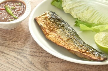 grilled Japanese saba mackerel fish and spicy shrimp chili paste sauce on plate eat couple with fresh vegetable