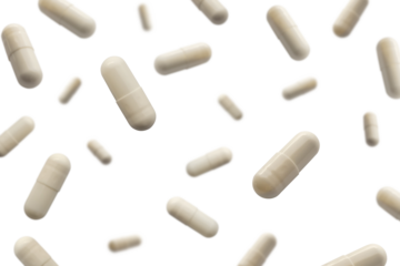 Falling white medicine pills capsule isolated on white background