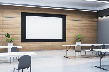 Modern empty classroom with blank screen for mockup display. 3D Rendering