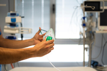 Doctor preparing oxygen mask in hospital room