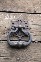 Old door knocker on a wooden door