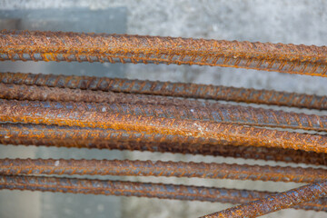 Close-up of a concrete foundation with a steel rebar cage inside, prepared for construction.