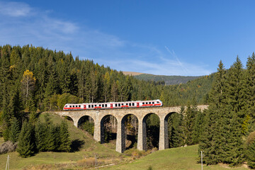 Modern diesel train, railway bridge Chramossky viadukt near Telgart, Horehronie, Slovakia © Richard Semik