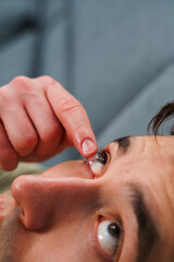 Vision correction with eye contact lenses chosen by ophthalmologist. Man is wearing daily contact...