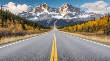 Asphalt Road Leading to Snowy Mountain Range in Autumn
