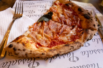italian neapolitan pizza with ham and basil  