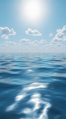 A serene view of a tranquil sea under a bright sun with soft fluffy clouds.
