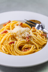 close up of spaghetti carbonara in white bowl