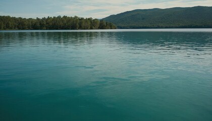 Blue green water surface. Night. Small waves. Ripples. Reflection of light.