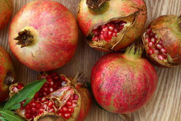 Seen from above, pomegranates at different stages of ripeness  placed on a wooden tray (Montpellier, Hérault, France)