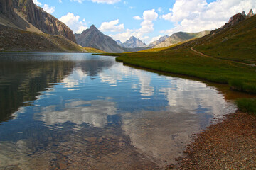 The calm waters of Lake Orrenaye reflect the sky, the Bec du lièvre and the Meyna (Ubaye Valley, Mercantour, Alpes de Haute Provence, France)