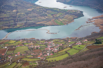 Aerial view of Kizilirmak River in Samsun, Turkey with misty mountains, settlements, hills and...