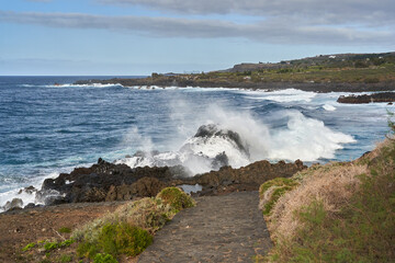 Waves crashing against volcanic rocks........