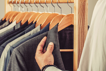 Suits hanging in a row. Men clothing, boutiques. Man suit, tailor in his workshop. Tailor