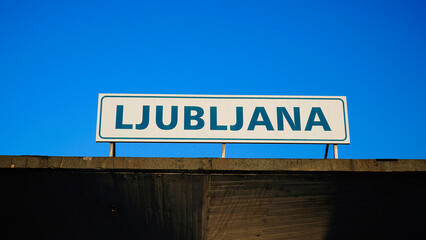 Ljubljana sign against a clear blue sky at the city entrance during a sunny day