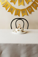 Homemade birthday dog cake with treats on top and candle with a number three. Decorated photo zone for pet birthday celebration at home