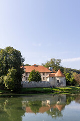 Fototapeta premium Scenic view of Otocec Castle at small island in Krka river in Slovenia