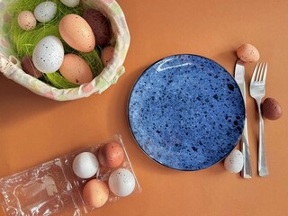 Easter still life. Festive table place setting decoration with colored eggs. 
